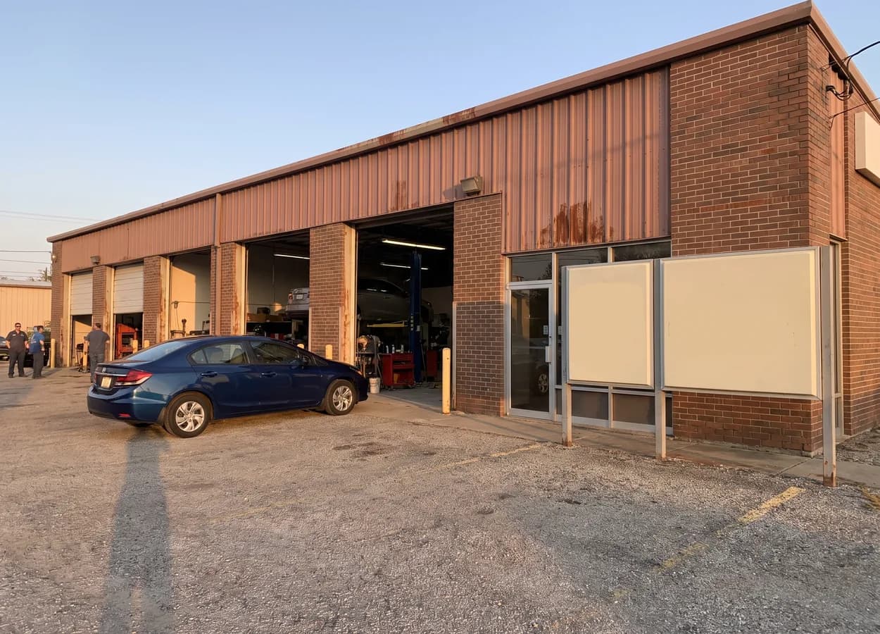 exterior of an independent collision repair shop with open service bays